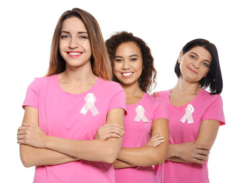 Group of women with silk ribbons on white background. Breast cancer awareness concept