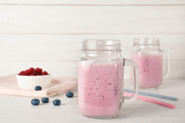 Composition with mason jars of healthy protein shake on table