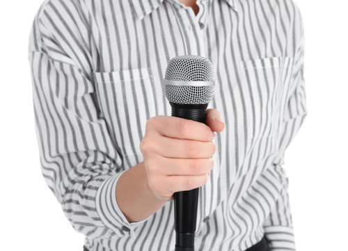 Young woman holding microphone on white background, closeup view
