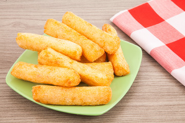 Fried cassava in wood background