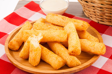 Fried cassava in wood background