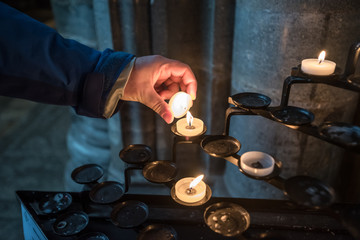 Fototapeta premium Lighting a Candle