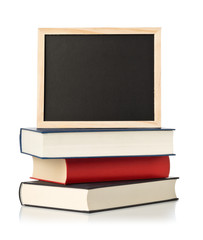 Empty, blank, black chalkboard with stack of books over white © Shawn Hempel