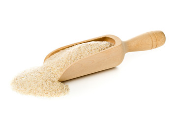 Heap of psyllium husk also called isabgol in wooden scoop over white background