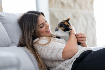 Woman holding her lovely black and white cat