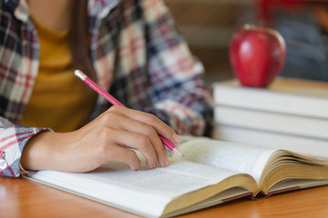 Students write books in the library, Education concept.