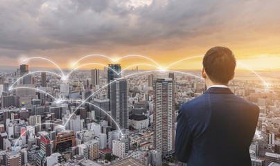 Business network technology, logistics and blockchain business. Businessman in blue suit with...