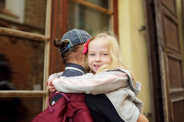 Young father carrying his adorable little daughter during summer city walk.