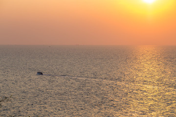 The background of the sea surface with colorful yellow gold, colorful colors on the surface from the sunset light, is a natural beauty. 