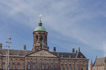 Fototapeta na wymiar Facade and clock tower of Royal Palace Amsterdam in the Dam Square in downtown Amsterdam, the Netherlands