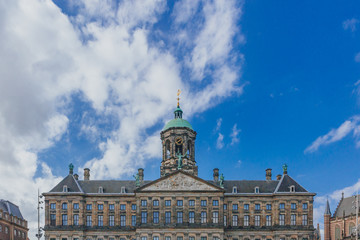 Fototapeta na wymiar Facade and clock tower of Royal Palace Amsterdam in the Dam Square in downtown Amsterdam, the Netherlands
