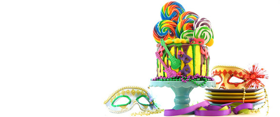 Mardi Gras theme on-trend candyland fantasy drip cake on white background.