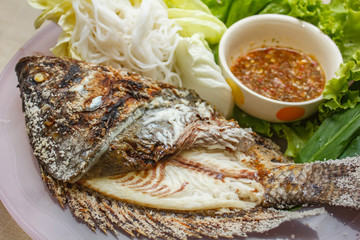 Salt-Crusted Grilled Fish and mix vegetable on plate.