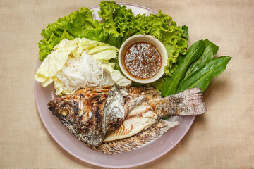 Salt-Crusted Grilled Fish and mix vegetable on plate.