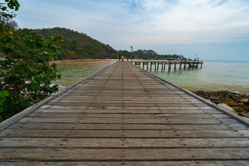 unidentified people at wooden plank pier bridge at Khao Laem Ya in Mu Ko Samet National Park, Rayong Province, Thailand