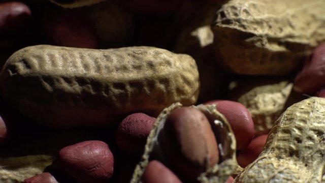 Peanuts. Mixed Peanuts in rotation. Snack closeup.  Peanuts in a bowl. Selective focus. black background. Studio shot. Healthy food concept.
