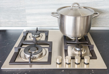 Metal Pot on induction hob in modern kitchen. modern kitchen pot cooking induction electrical stove...