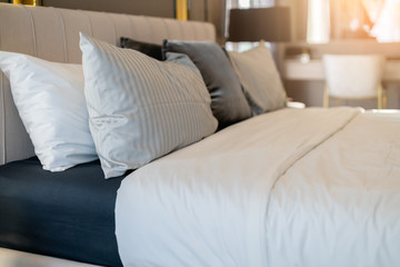Bed maid-up with clean white pillows and bed sheets in beauty bedroom. Close-up. interior background