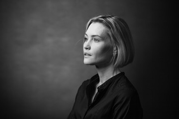 Dramatic black and white portrait of a beautiful woman on a dark background