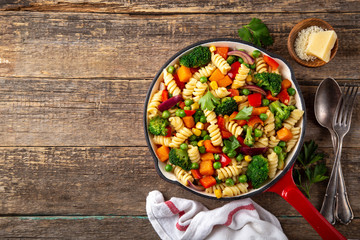 pasta with vegetables ( bell pepper, green peas, broccoli, pumpkin and corn) on pan.tif