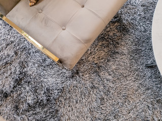 close up armchair gold brass leg on carpet rug living room