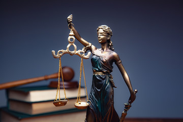lady justice with books on table