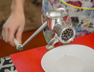 man works with a meat grinder