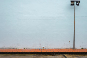 light blue wall and floor and light post side view walk way 