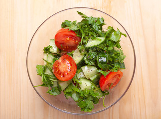 salad in transparency glass bowl on wooden table