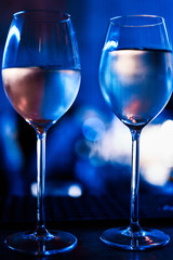 Glasses of champagne are in a row on a dark background