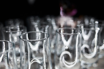 Glasses of champagne are in a row on a dark background