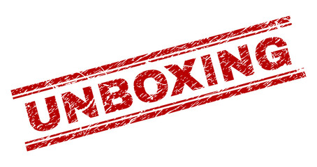 UNBOXING seal print with corroded style. Red vector rubber print of UNBOXING tag with corroded texture. Text label is placed between double parallel lines.