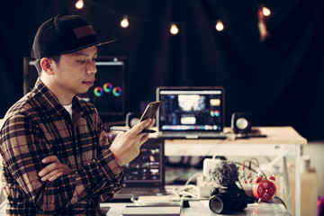 Editor man checking email on mobile and connecting online or watching video clip