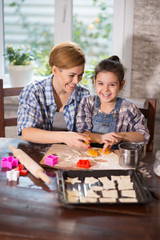 Mom and daughter prepare cookies in the kitchen