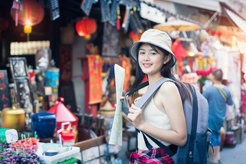 Fototapeta na wymiar Woman traveling backpack,Asian traveler standing and walking in china town