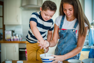 Sister and brother baking in the kitchen