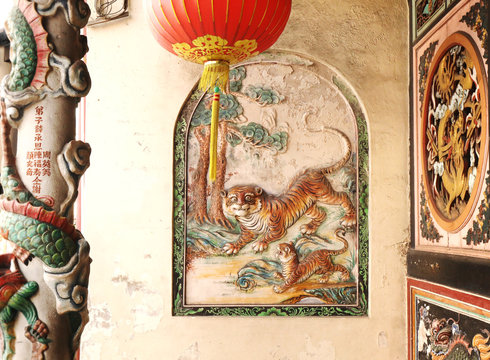 Decorative bas-relief with tigers on a temple&acute; wall in Malaka malasya