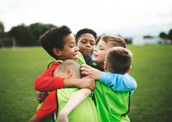 Fotobehang Voetbal Junior football team hugging each other  © Rawpixel.com