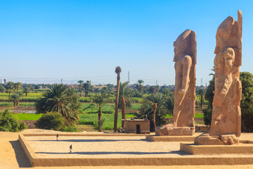 Recently raised quartzite Colossi of Amenhotep III at the Northern Gate of the temple of Luxor,...