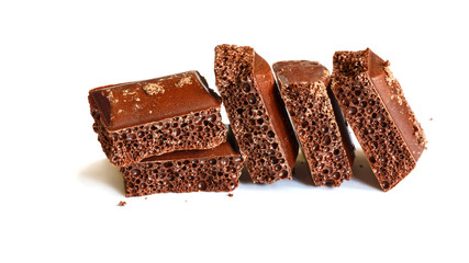 Delicious dark porous chocolate isolated on a white background close up