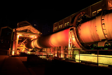 idle cement plant rotary kiln machinery at night