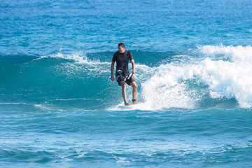 Surfer on blue Atlantic Ocean wave. Tropical winter.  Shortboard.