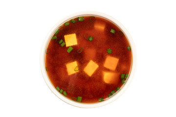 A bowl of miso shiru soup with tofu and scallions, isolated on a white background with a clipping path