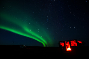 aurora borealis in iceland with small house 