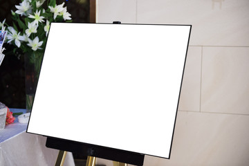 A empty frame for copying other Photo or painting in front of white wall on easel.