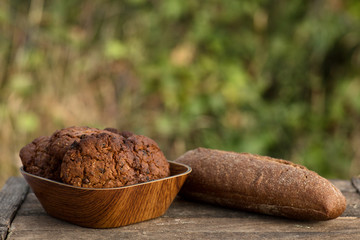 Assortment of fresh baked goods wooden background. baguette and cookies in the open space