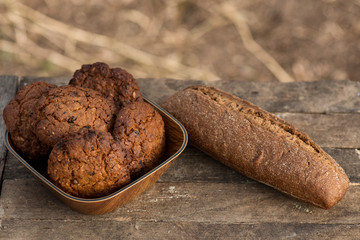 Assortment of fresh baked goods wooden background. baguette and cookies in the open space