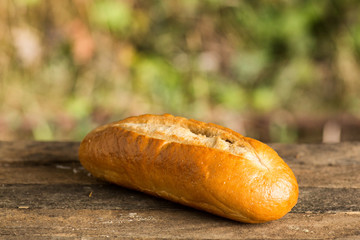 Assortment of fresh baked goods wooden background. baguette and cookies in the open space