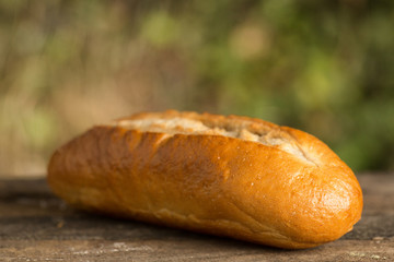 Assortment of fresh baked goods wooden background. baguette and cookies in the open space