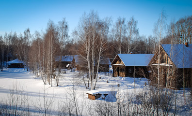 Winter landscape with a huts